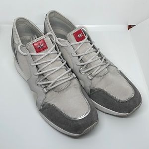 Michael Kors wedge style gray sneaker with suede trim and silver accents.